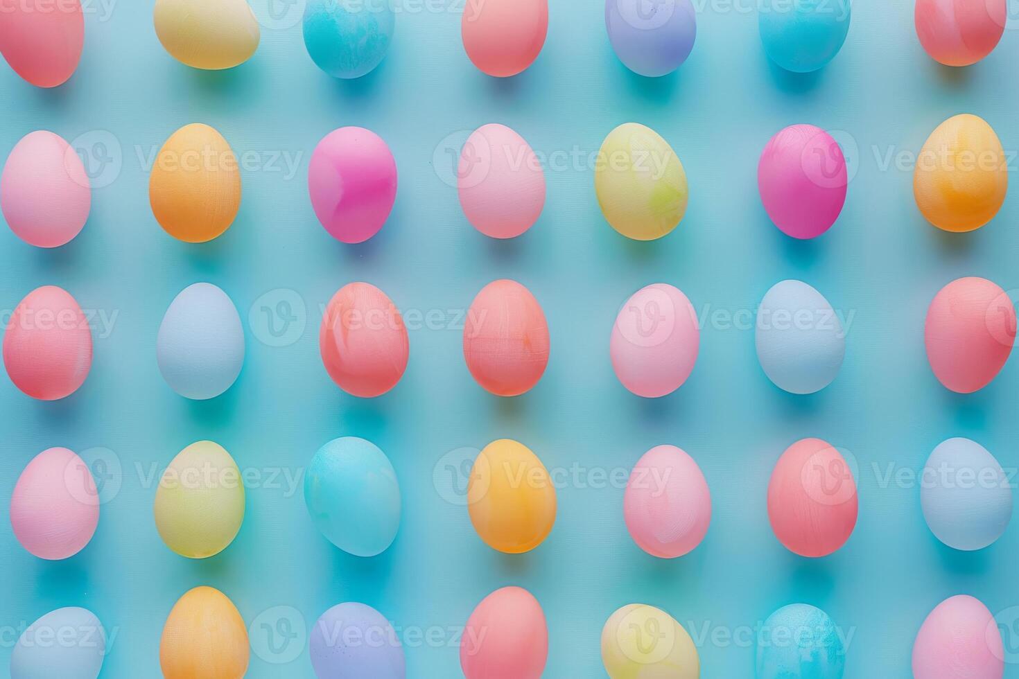 Colorful Easter eggs arranged in a pattern against a pastel backdrop photo