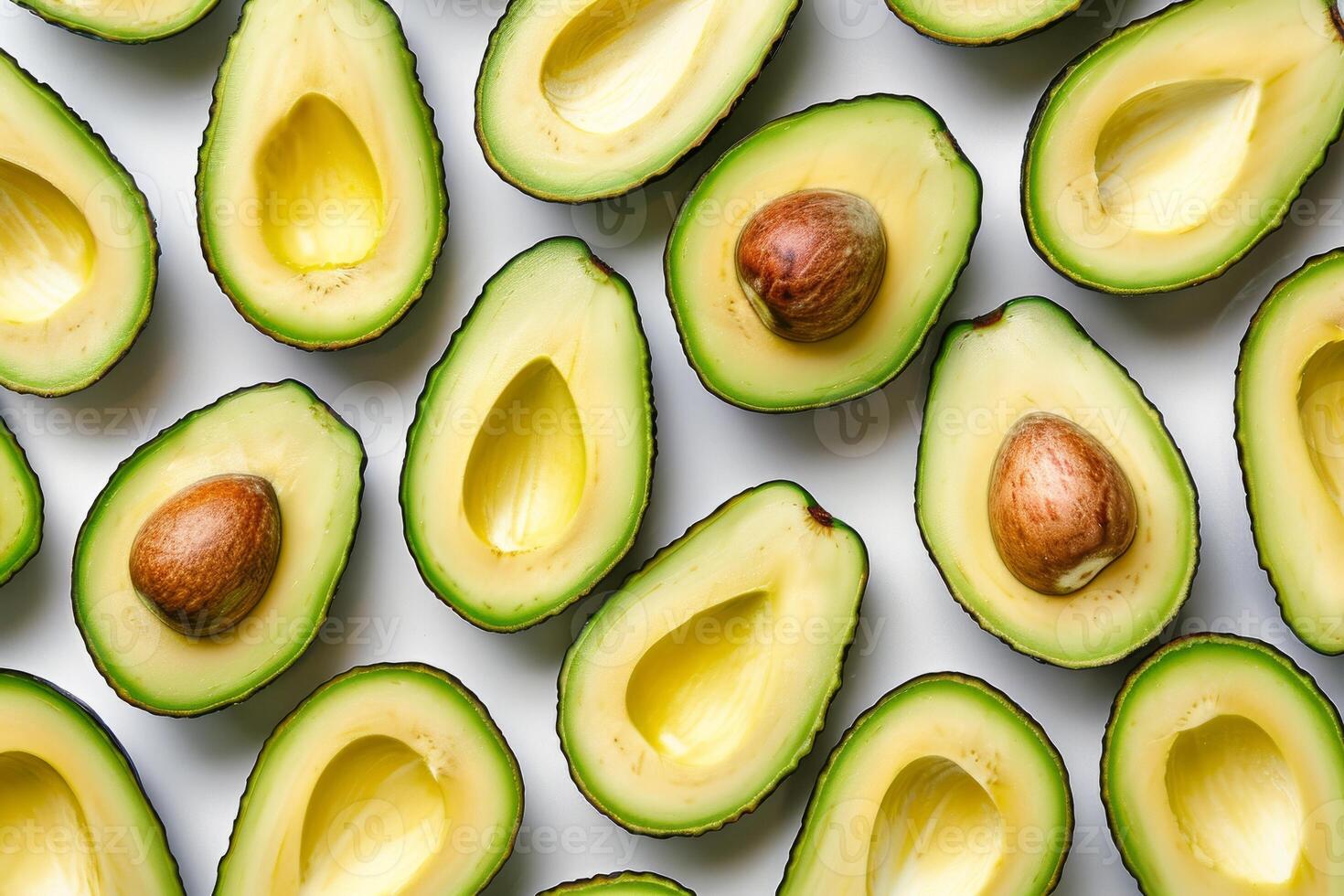 Sliced ripe avocado arranged neatly on a transparent white surface photo