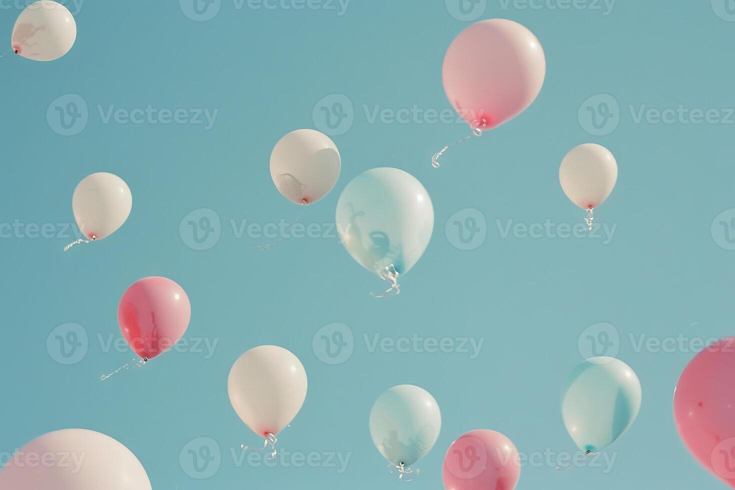 Pastel-colored balloons floating in a clear blue sky, creating a peaceful and serene scene photo