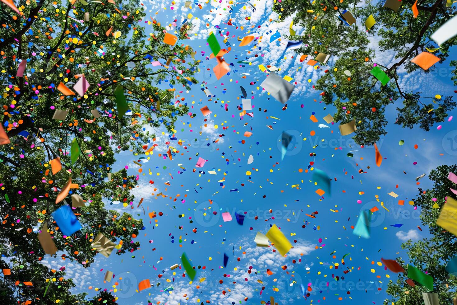 Rainbow-colored paper confetti falling transparently from the sky in celebration photo