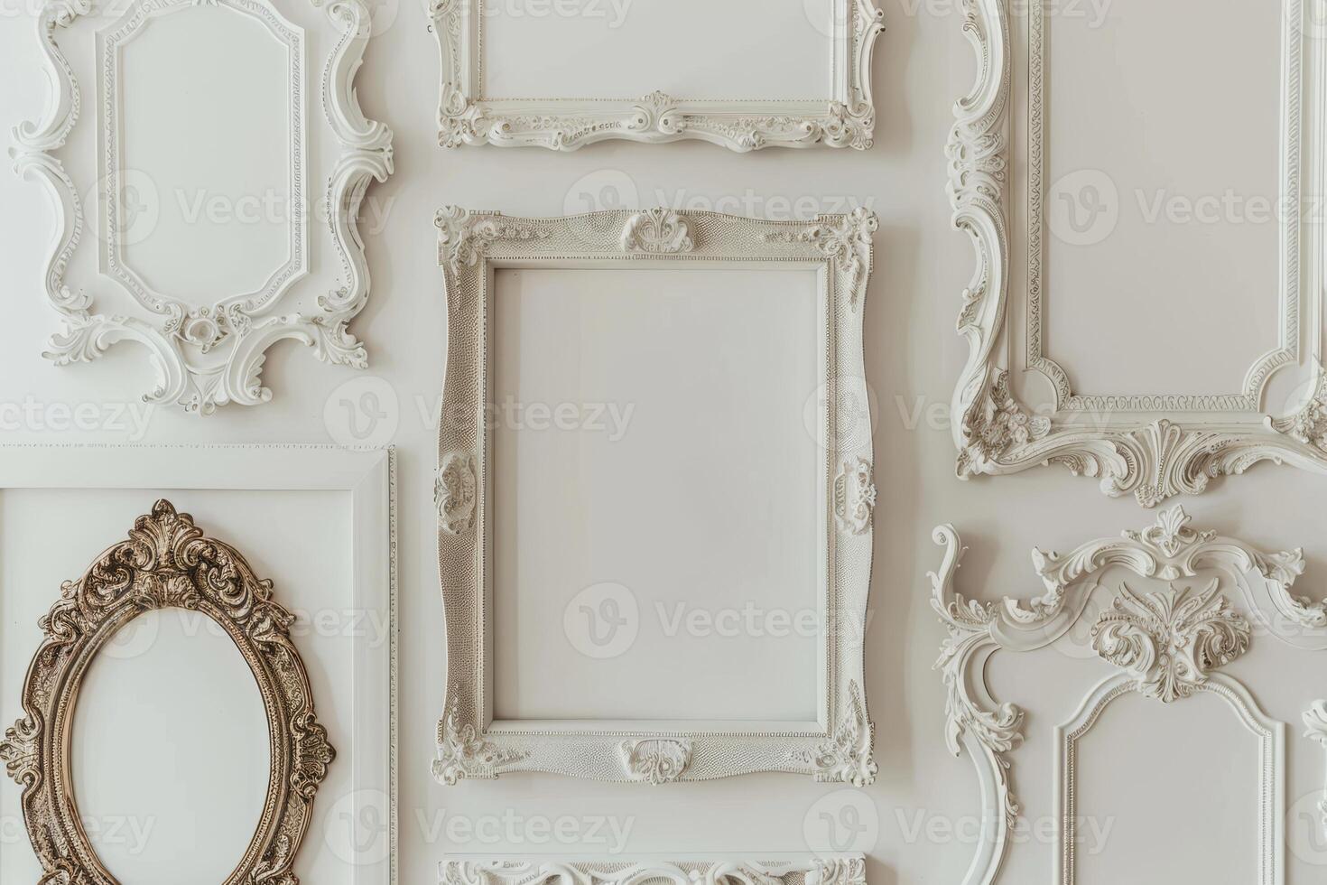 A collection of white frames with a white frame in the middle. The frames are all different shapes and sizes photo