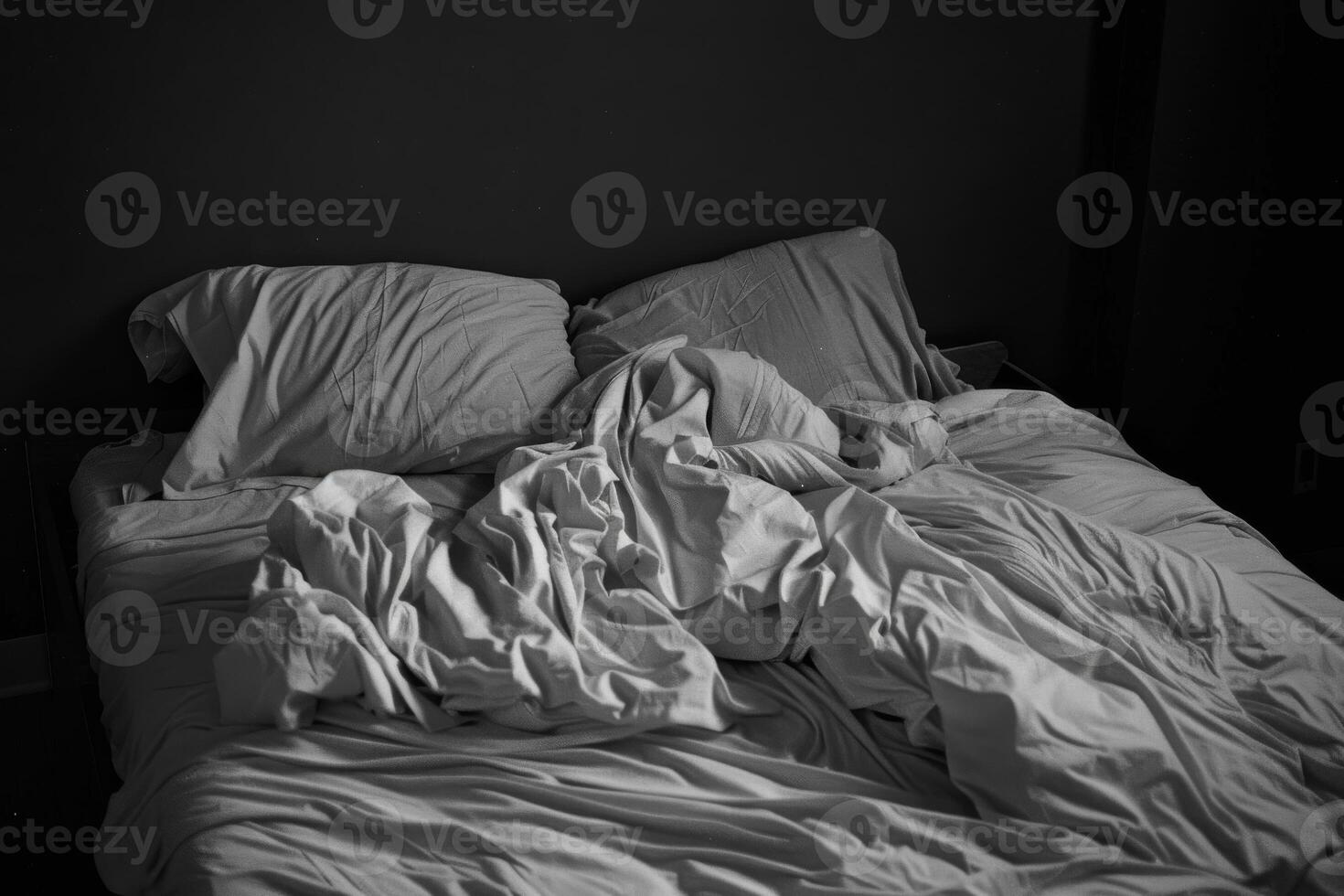 Empty bed with tousled sheets, showing the restless movements of insomnia photo