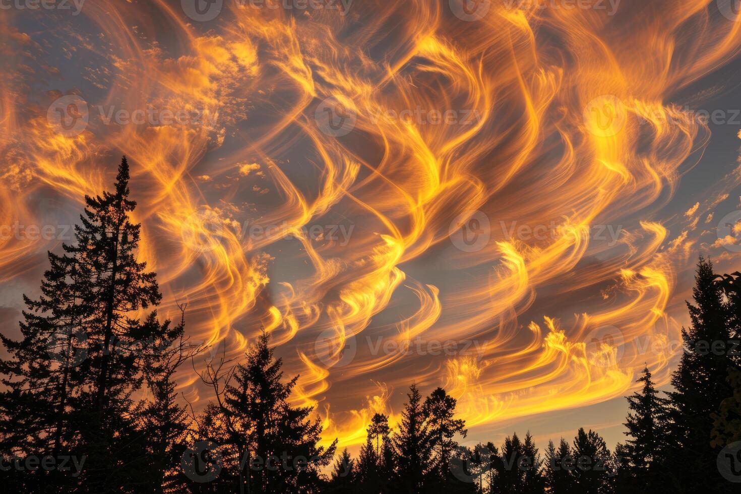 Wispy clouds illuminated by the setting sun, creating a warm and inviting atmosphere photo