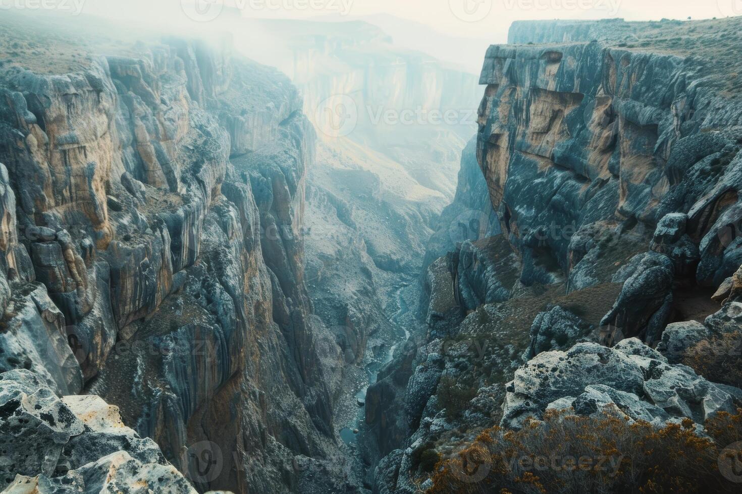 A breathtaking canyon vista, with sheer cliffs plunging into a deep gorge below photo