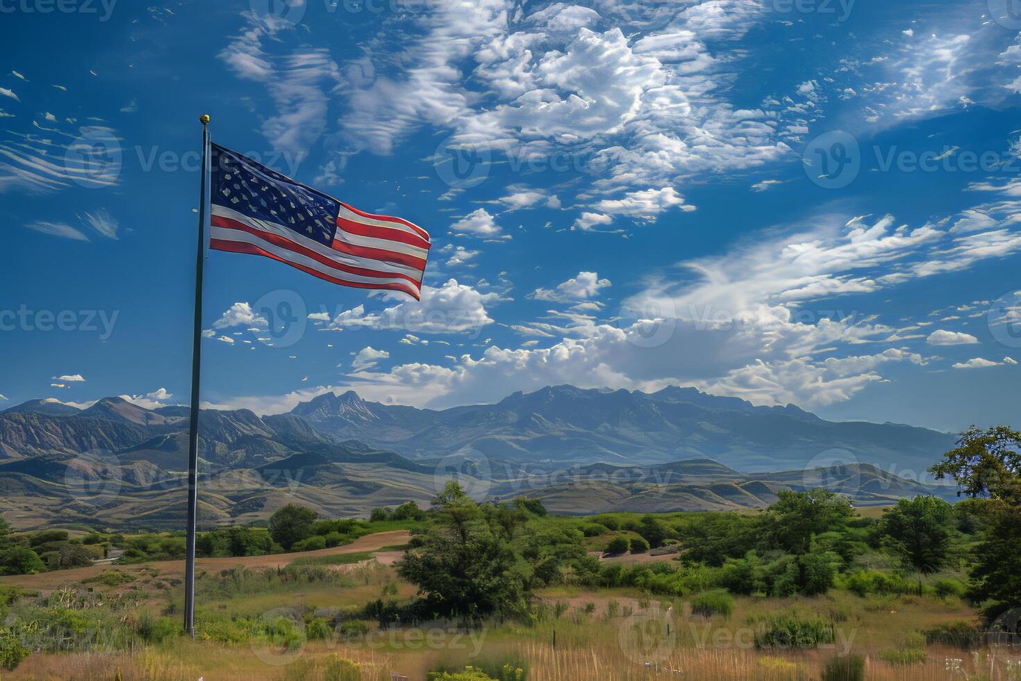 American flag on a pole against a mountain landscape photo
