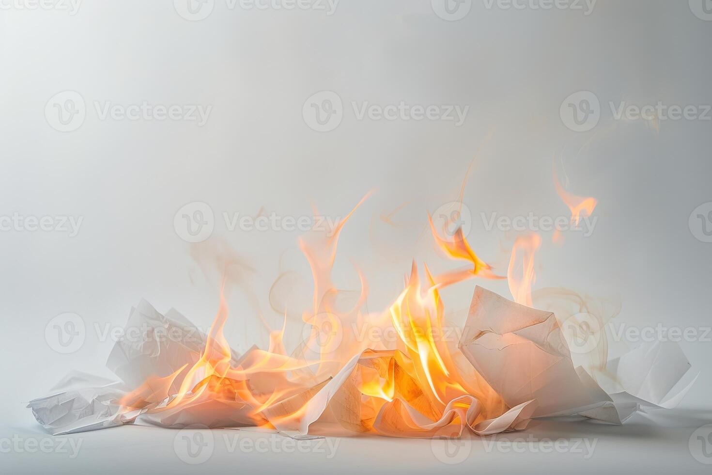 Burning paper engulfed in flames against a soft transparent white background, symbolizing destruction and transformation photo