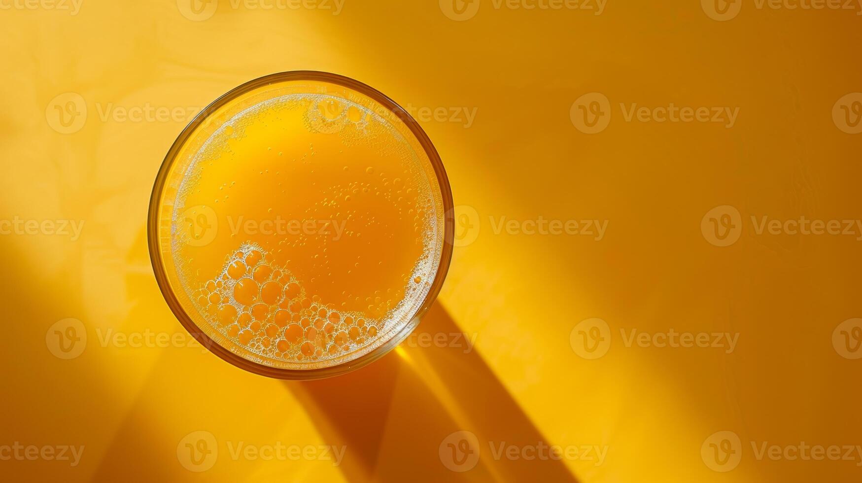 Top-down view of a spinning glass of orange juice with copy space photo
