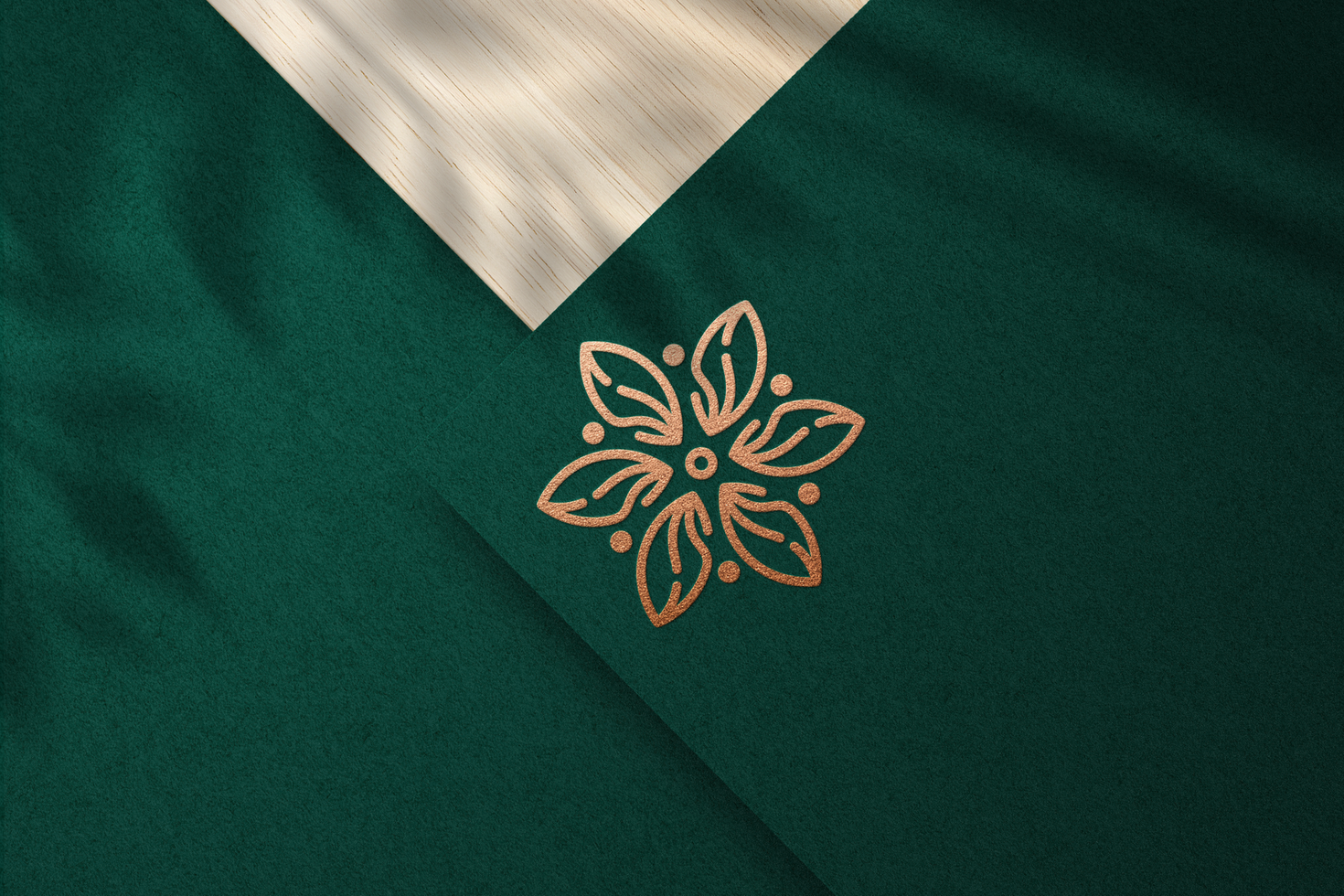 Realistic Embossed Logo Mockup with Bronze Foil on Green Paper psd
