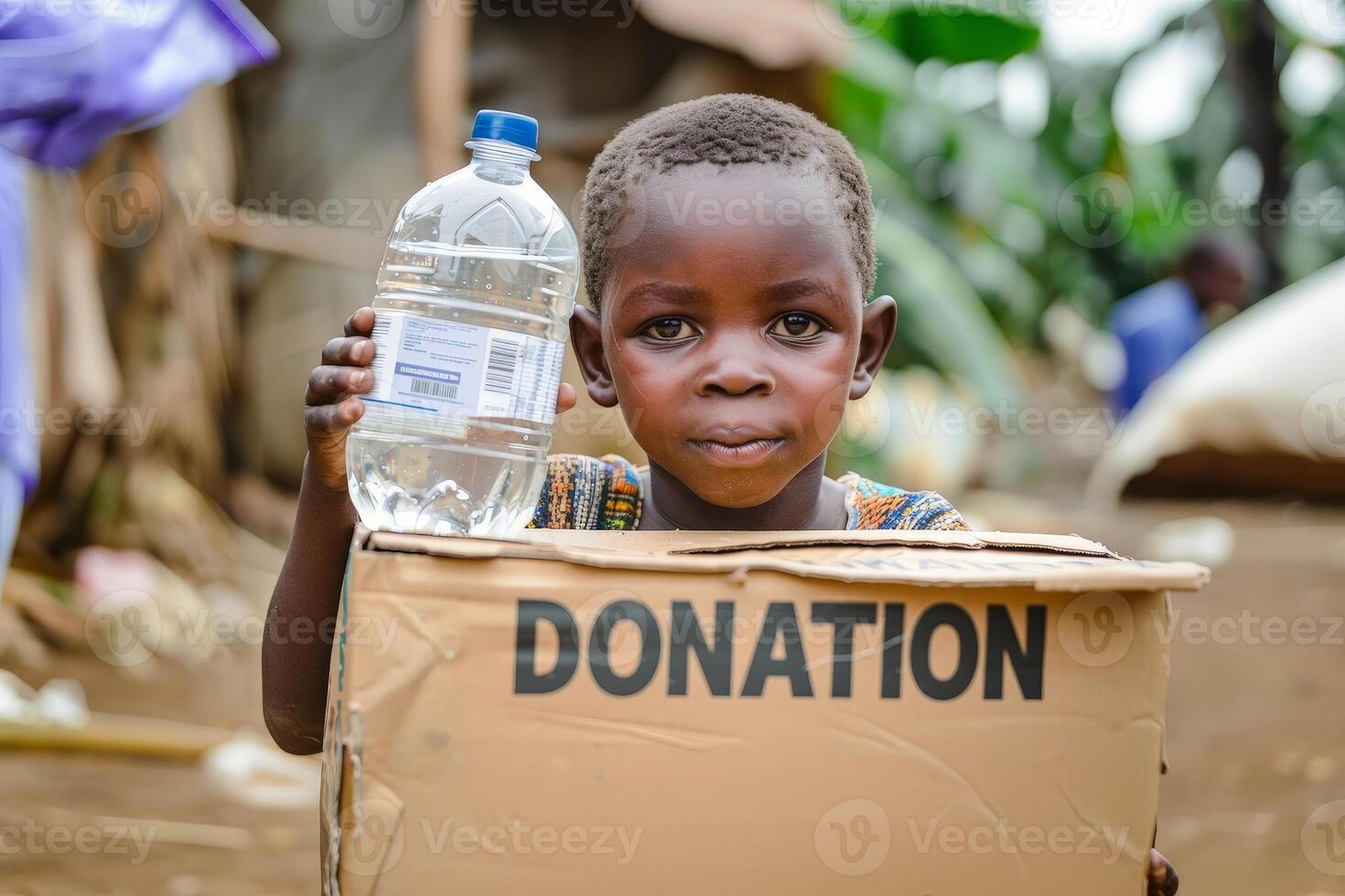 A young black boy is holding a box that says donation on it. photo