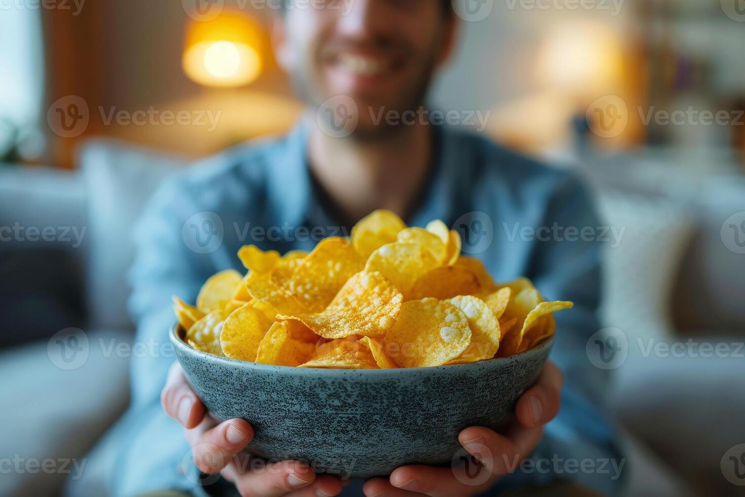 A man is holding a bowl of chips and smiling.ai geneative photo