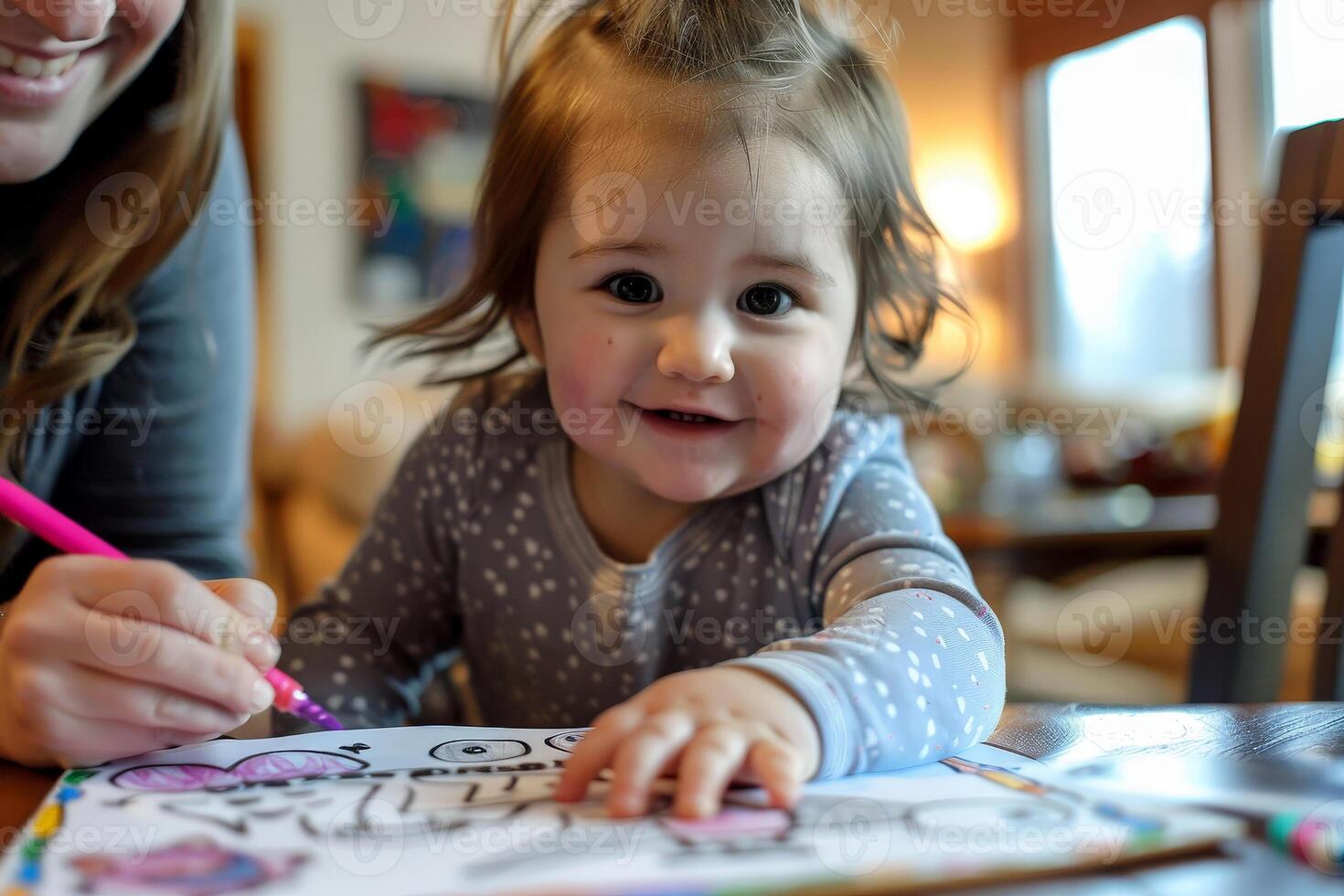 a daughter with mom drawing a coloring book. photo
