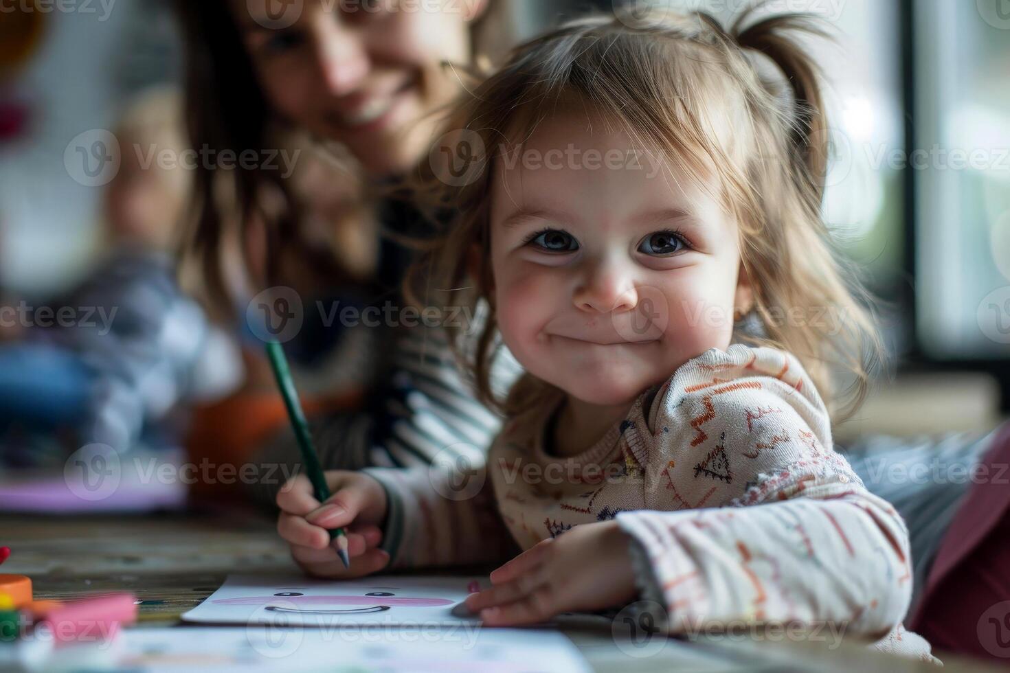 a daughter with mom drawing a coloring book. photo