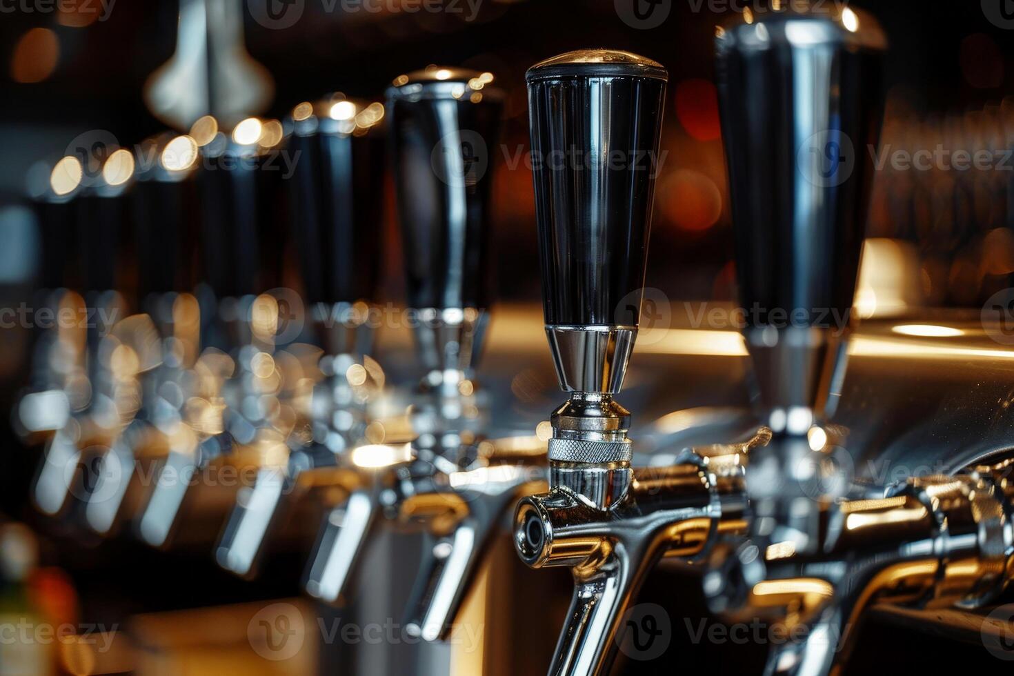 Closeup of beer tap handles lines in a bar against a dark background photo