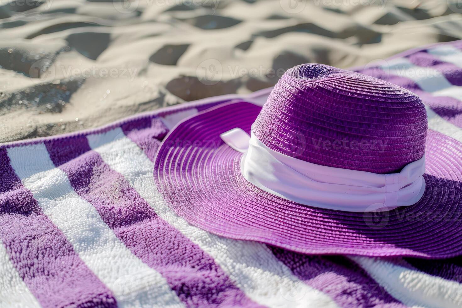 Purple and White Striped Hat on Beach Towel by the Seashore. summer vocation concept photo