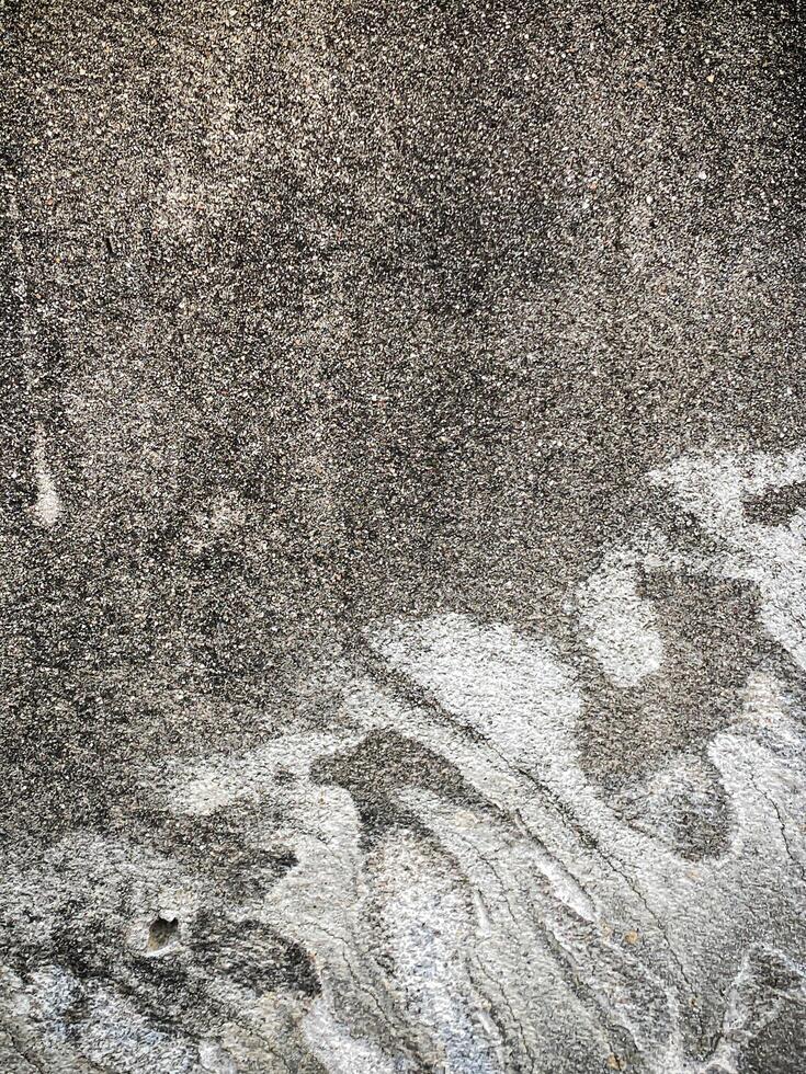 A white wall with a hole in it. The wall is cracked and has a rough texture photo