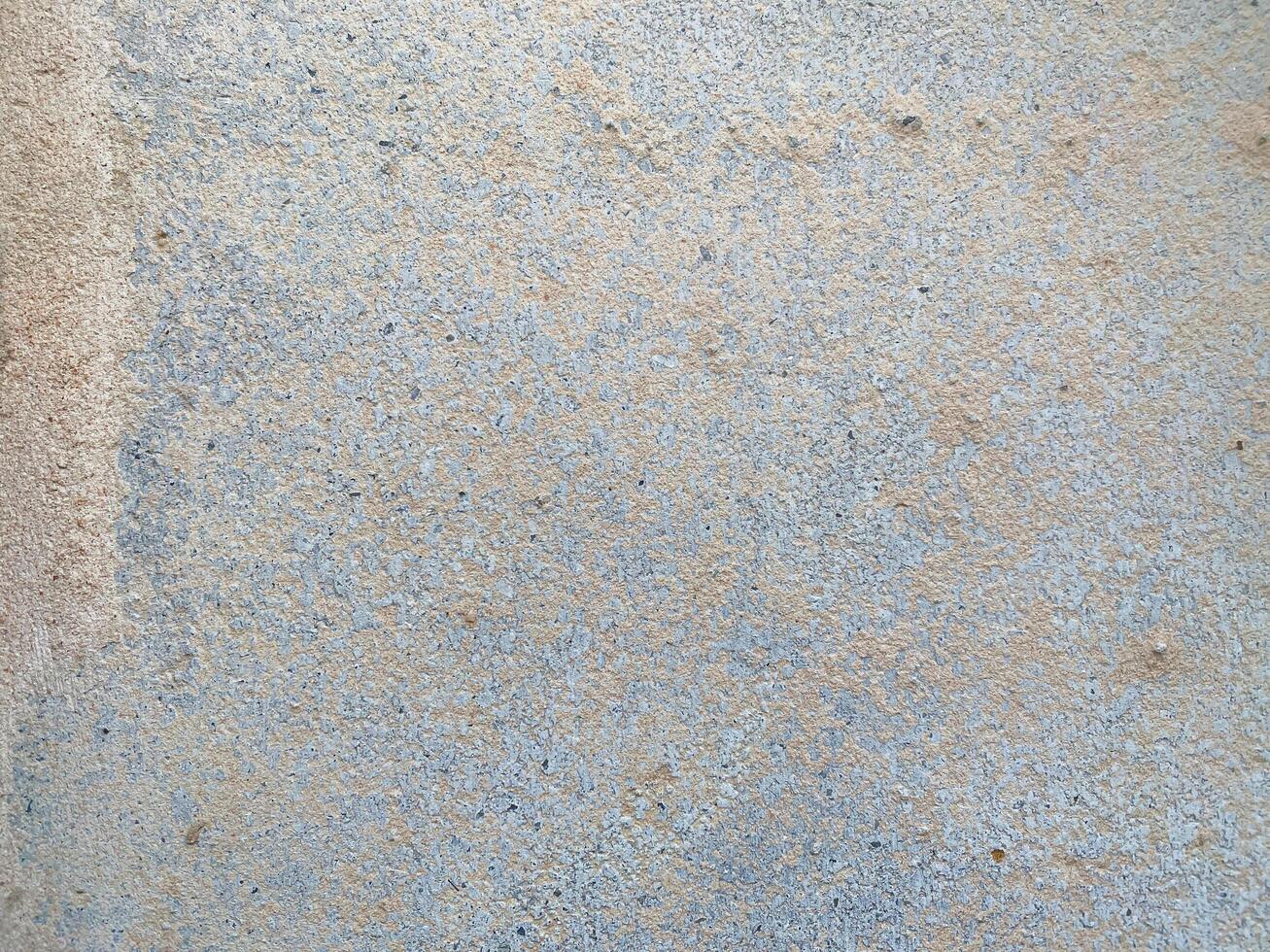 A white wall with a hole in it. The wall is cracked and has a rough texture photo