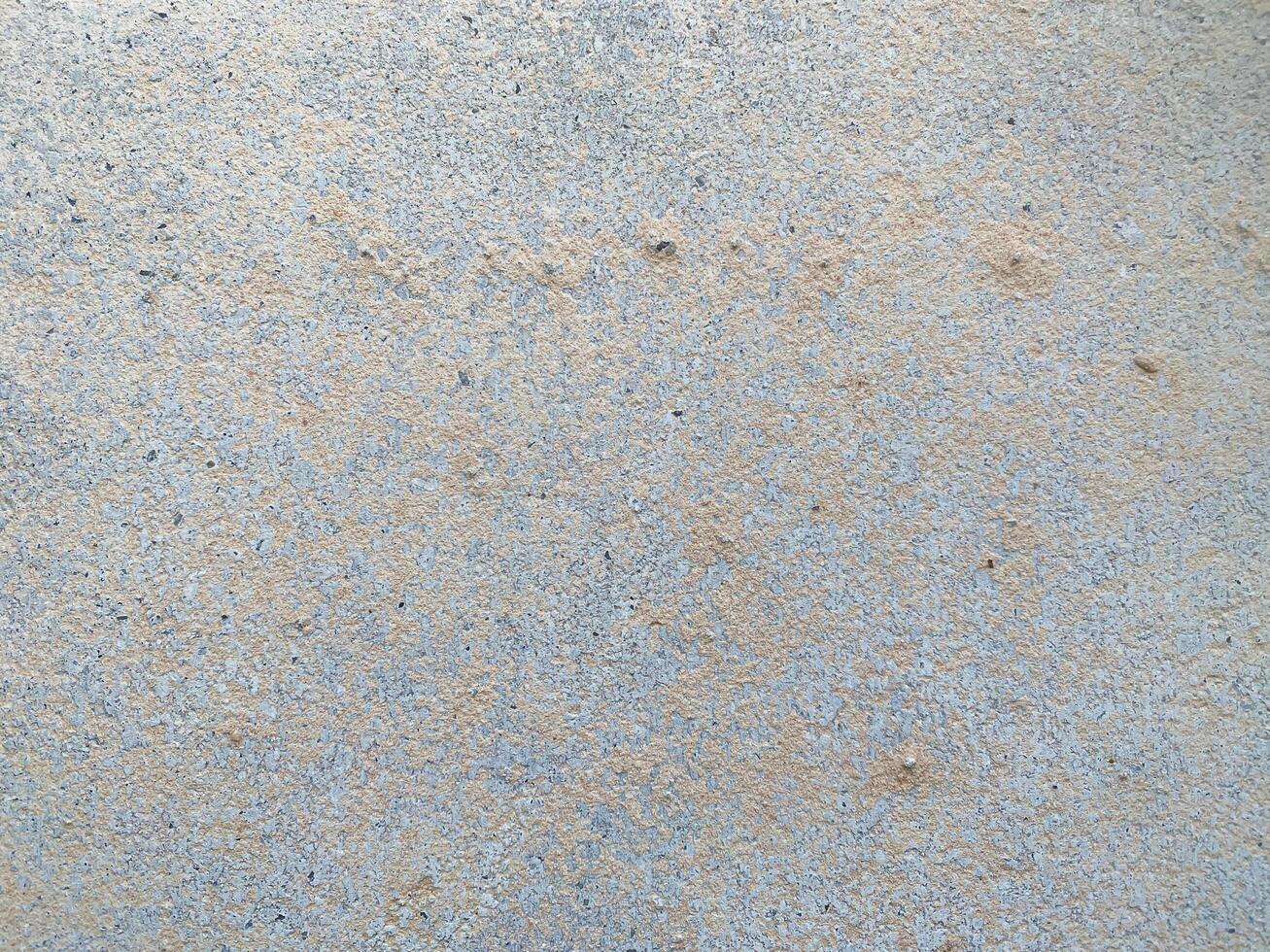 A white wall with a hole in it. The wall is cracked and has a rough texture photo