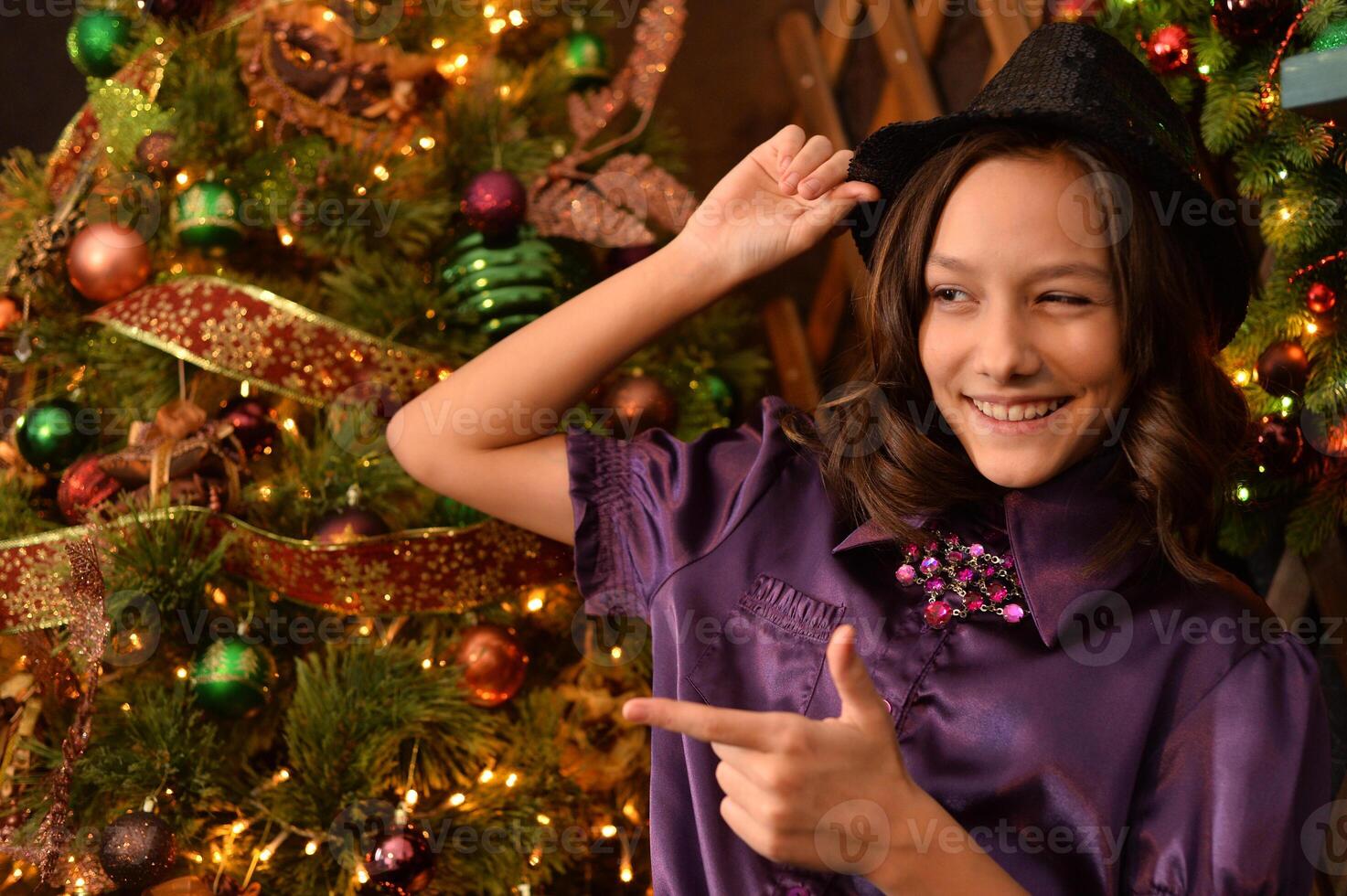 Portrait of little pretty girl near Christmas tree photo