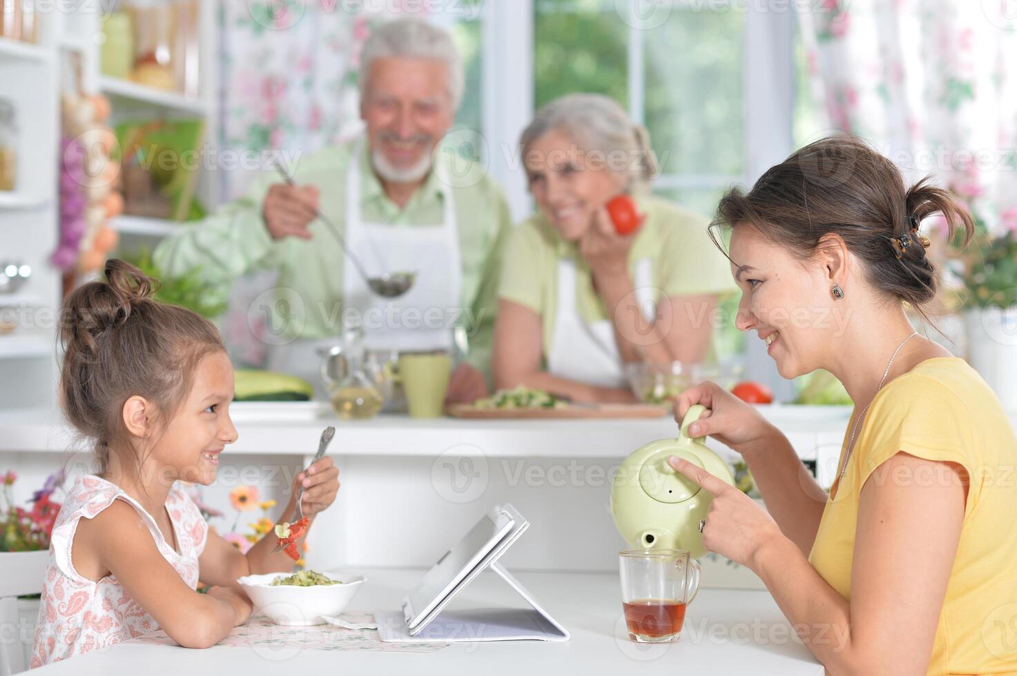 Portrait of mother and daughter having breakfast photo
