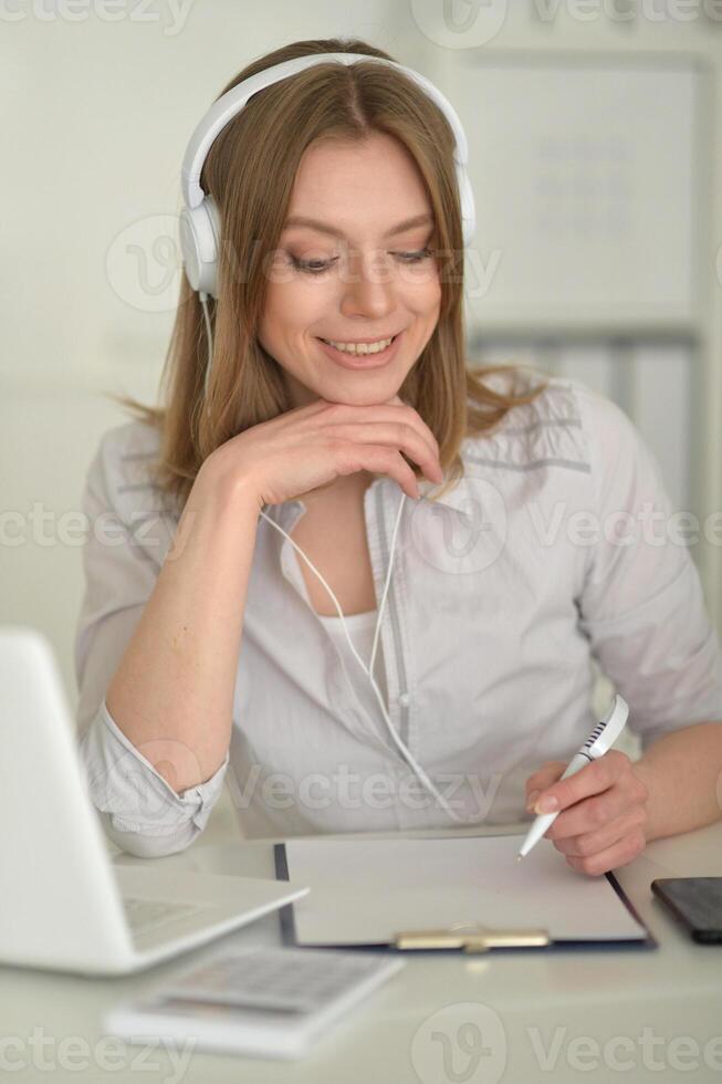 Young beautiful girl working on her laptop photo