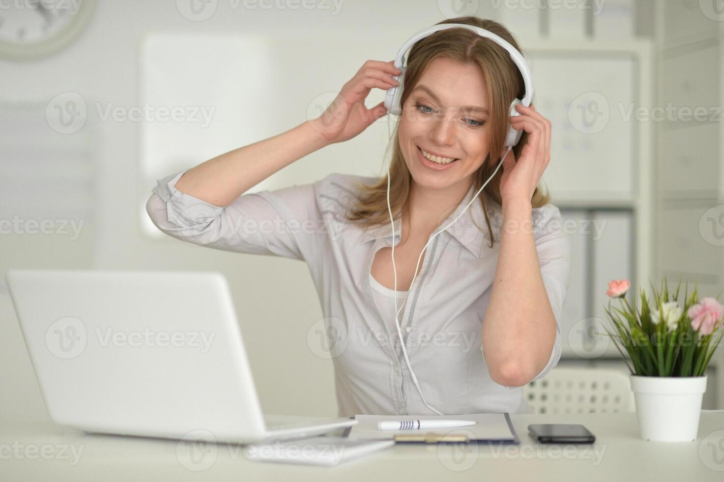 Young beautiful girl working on her laptop photo