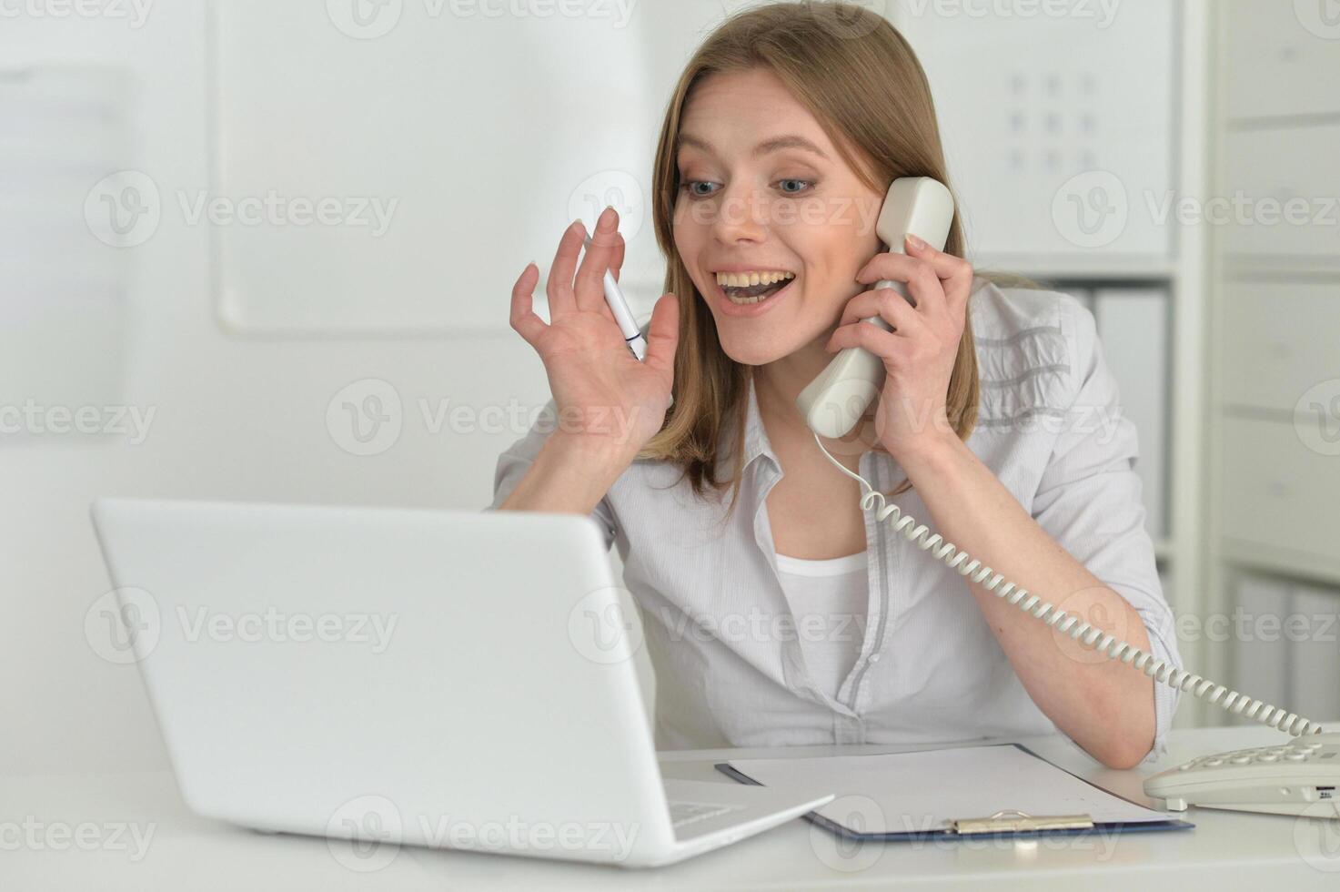 Female office worker reacting to phone call. photo
