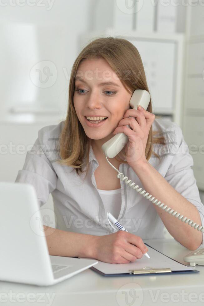 Female office worker reacting to phone call. photo