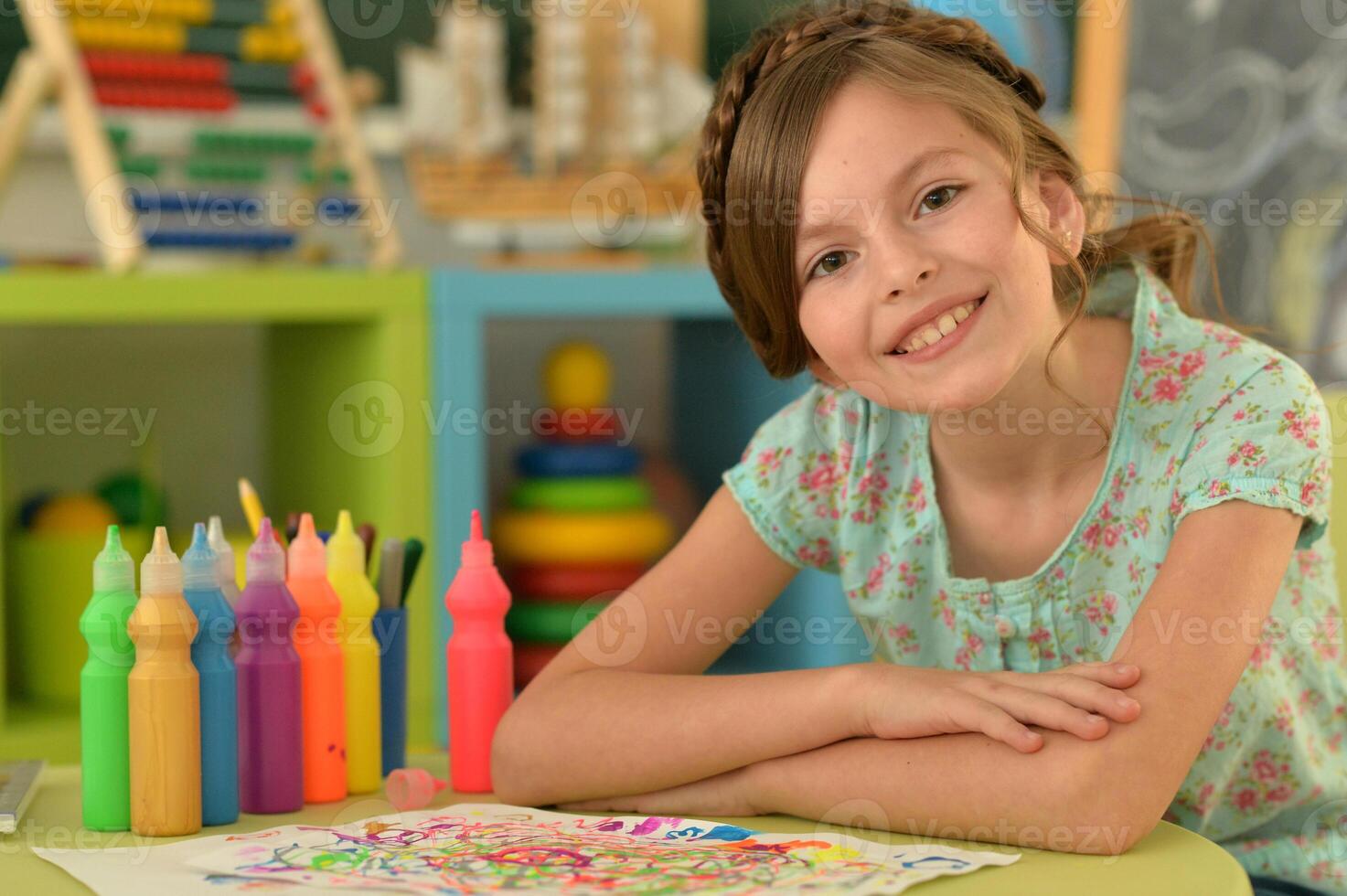 Portrait of cute girl drawing picture at home photo