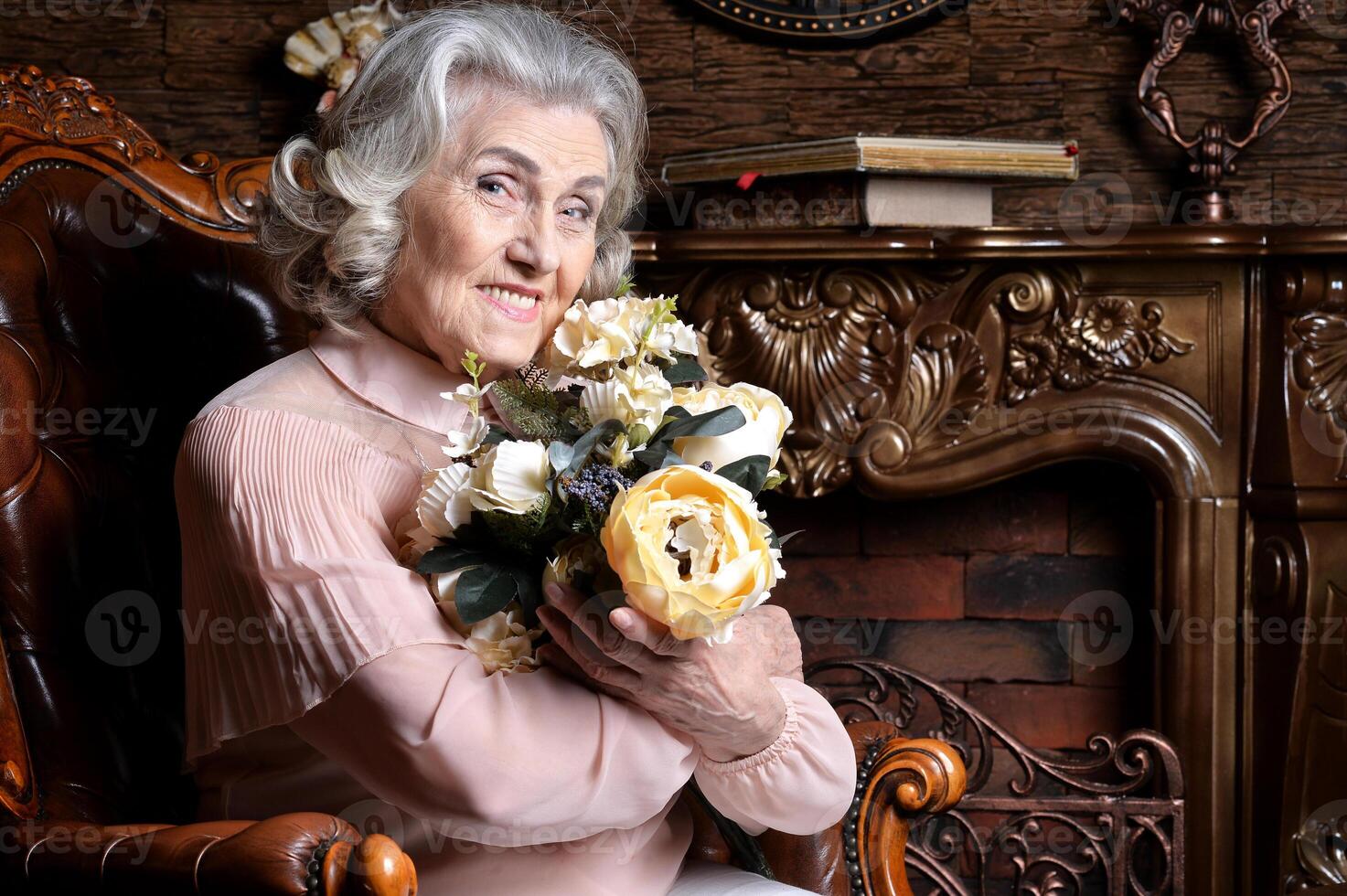 Portrait of senior woman posing with flowers photo