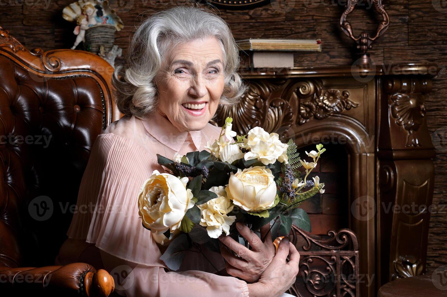 Portrait of senior woman posing with flowers photo