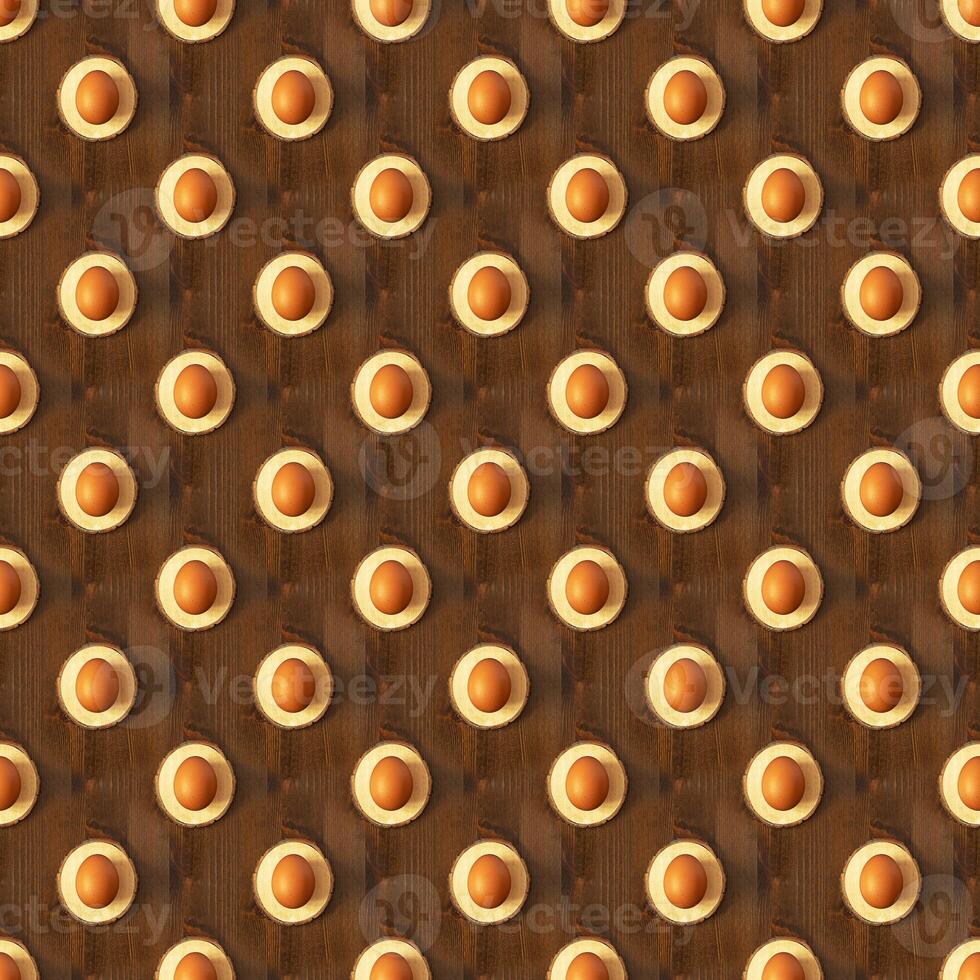 Seamless pattern of brown eggs on a light podium on a dark brown wooden background photo