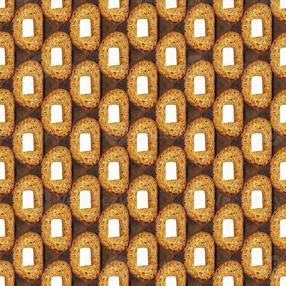 Seamless pattern of slice of dark rye bread with a piece of butter on a brown background photo