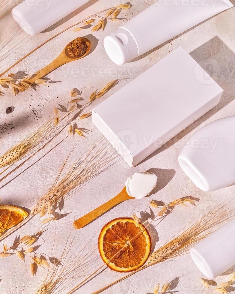 Spa composition with cosmetics botles, boxis and wooden spoons with fresh ingredients photo