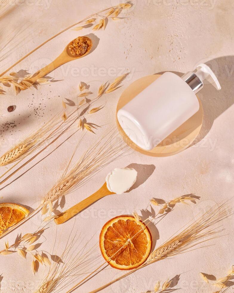 Spa composition with cosmetic bottle and wooden spoons with natural ingredients photo