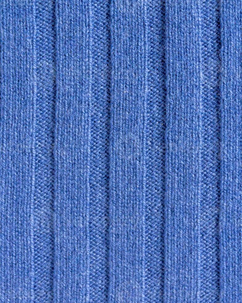 Texture of expensive natural knitted blue fabric with a striped pattern and a beautiful weave photo