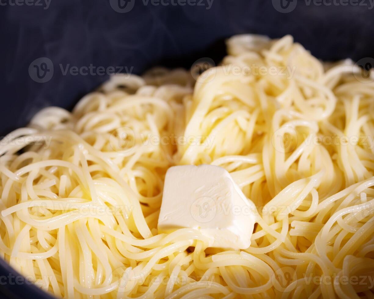 Hot traditional spaghetti with a piece of butter photo