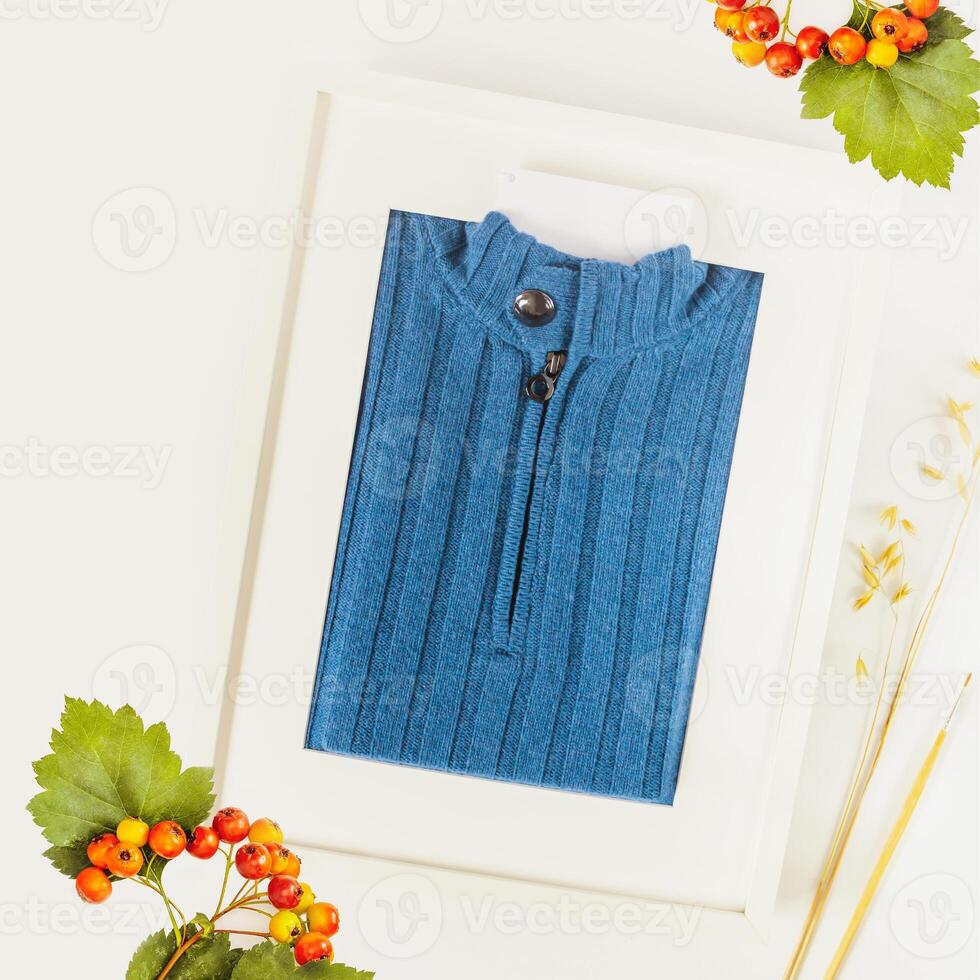 Knitted sweater made of expensive, natural fabric packed like a picture in a frame with a label for your brand photo