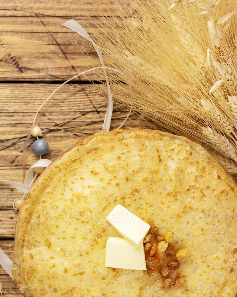 Home made fried crepes, jar with honey, sheaf of wheat photo