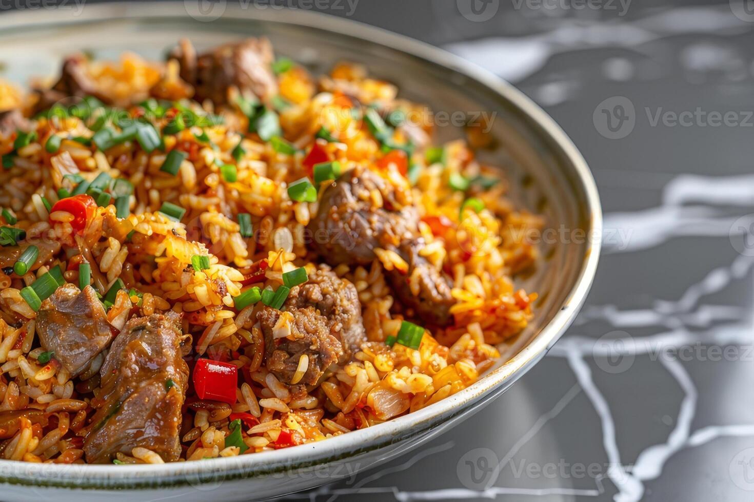 A plate of Kebuli with mutton on a marble countertop photo