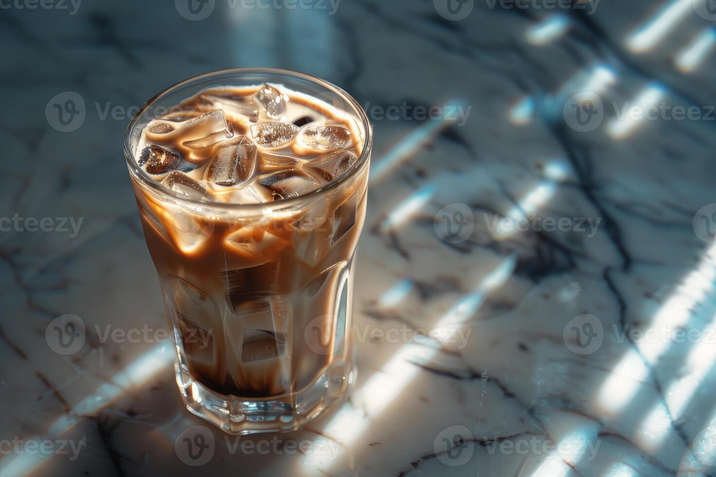 A cup of iced coffee on a marble countertop photo