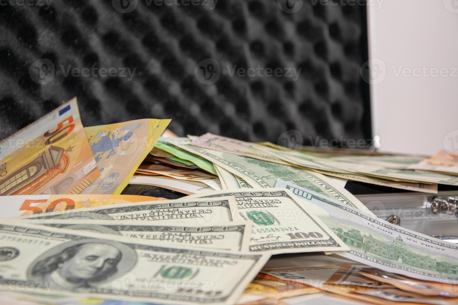 Close-up of a stack of US dollar and euro bills in a case photo