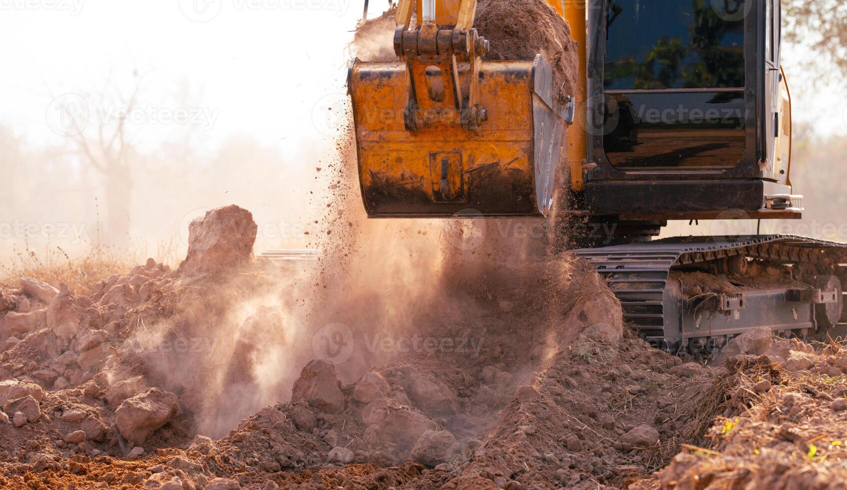 Close-up of excavator at construction site. Backhoe digging soil for earthwork and construction business. Excavating machine at work. Heavy machinery for earth moving and construction site development photo
