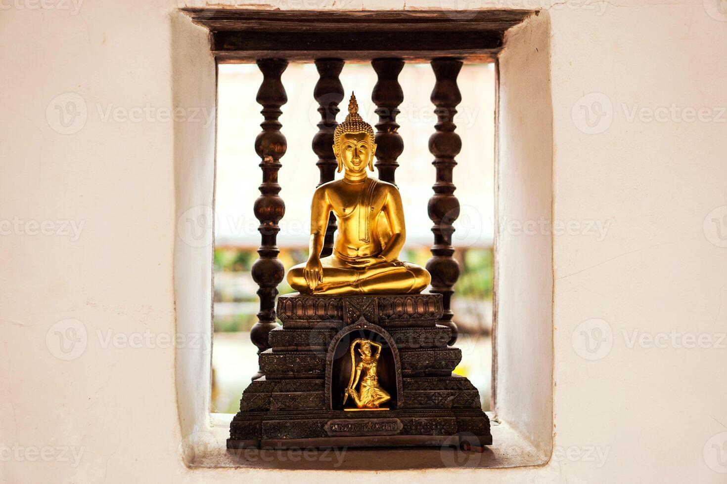 Closeup a small golden Buddha statue on wall of the temple. Believe, Culture of Asia, Traditional. Buddhist believe, Calm meditation concept photo