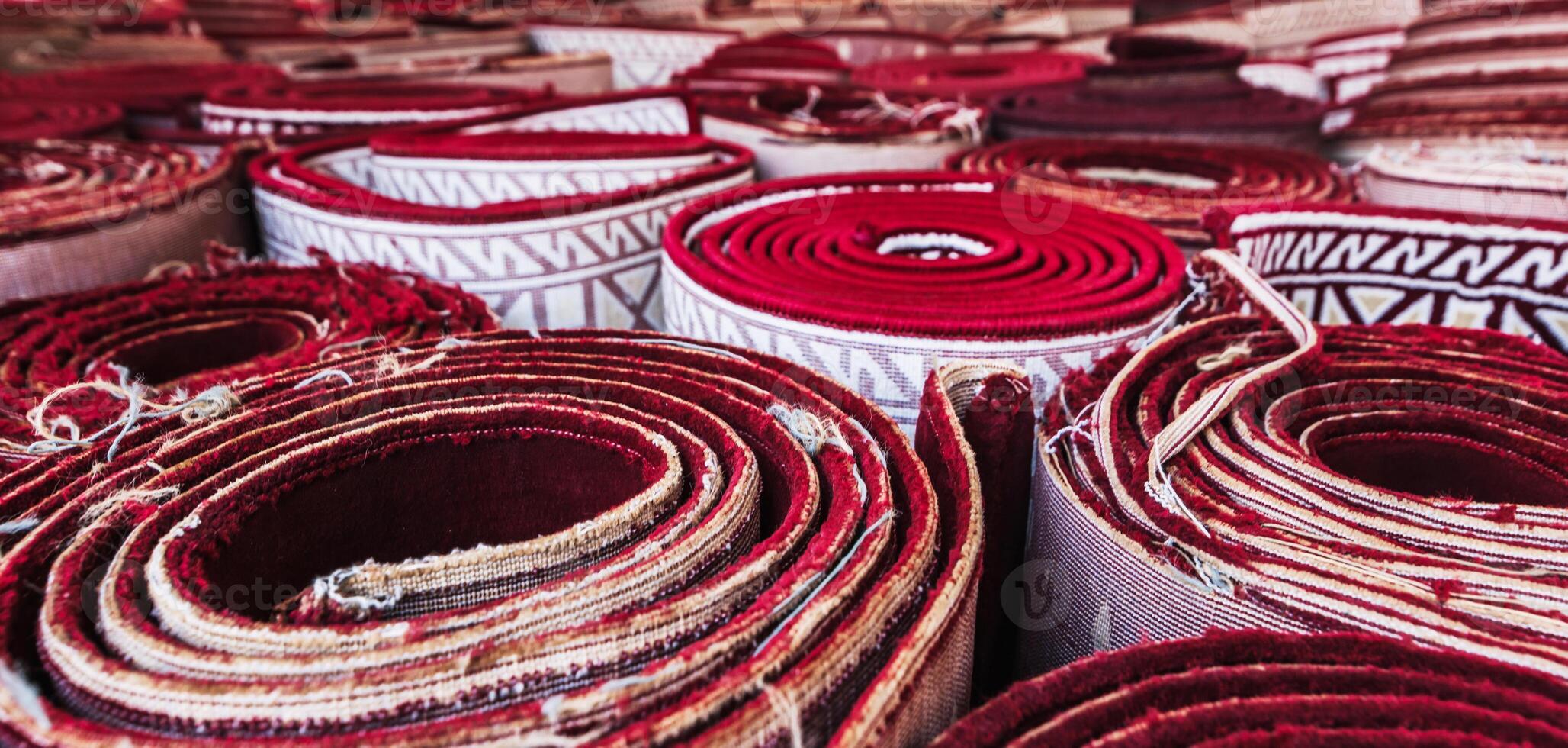 stack of rolled up tradition carpets for prayer Minor Mosque in Tashkent in Uzbekistan photo
