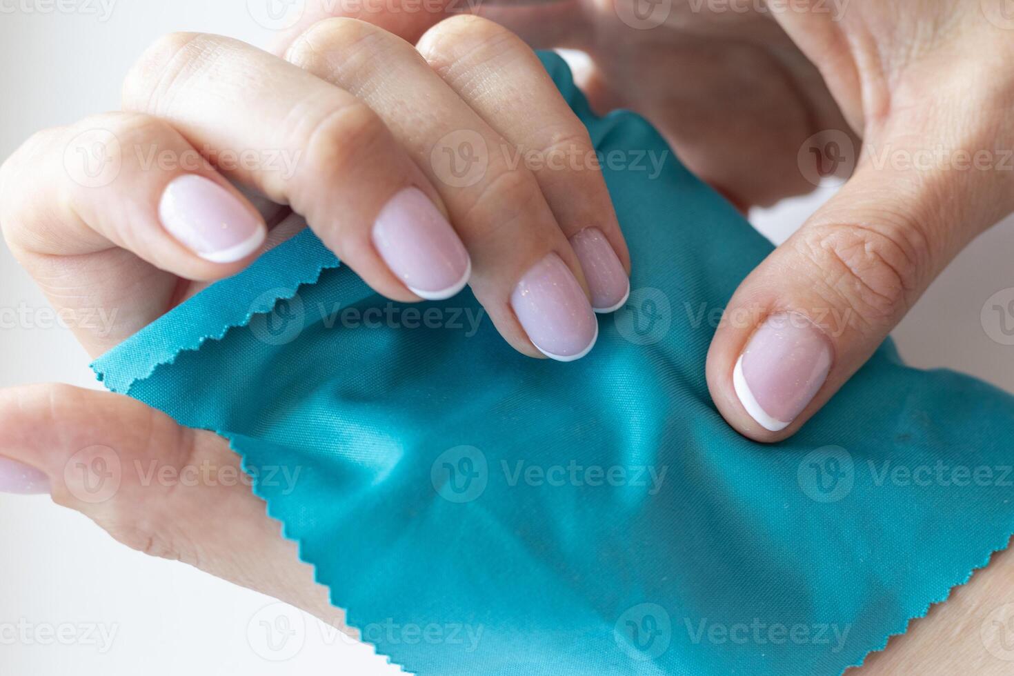 Shot of the beautiful woman's hand holding piece of vivid, bright cloth. Fashion photo