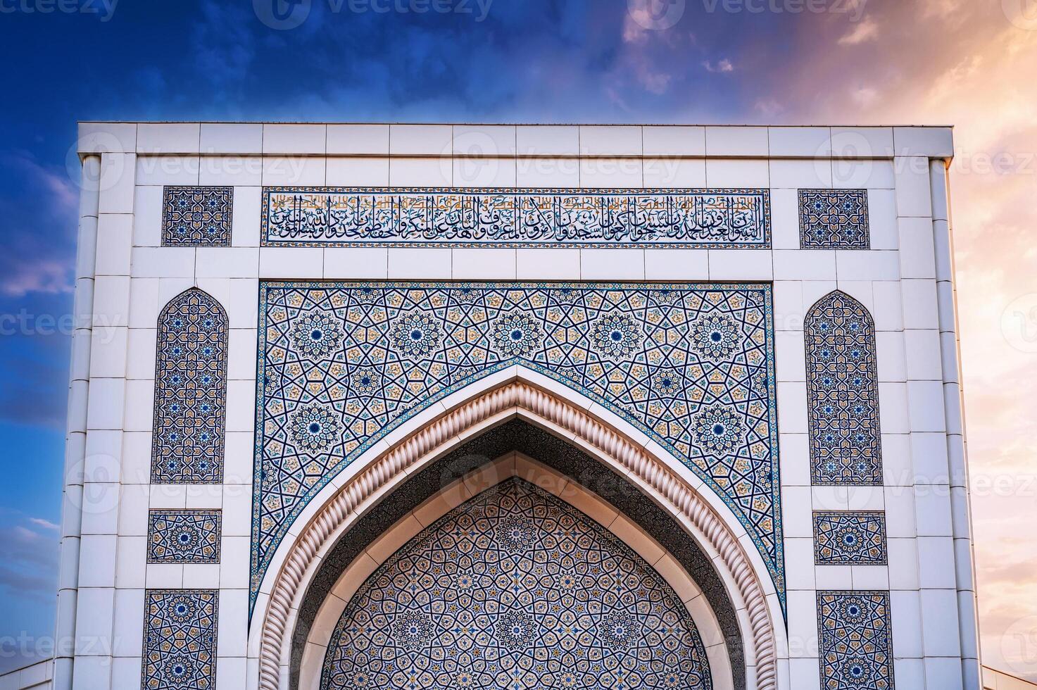 white marble tiles decorated with traditional Uzbek Islamic pattern ornament on the wall Minor Mosque in Tashkent in Uzbekistan on background of beautiful sky photo
