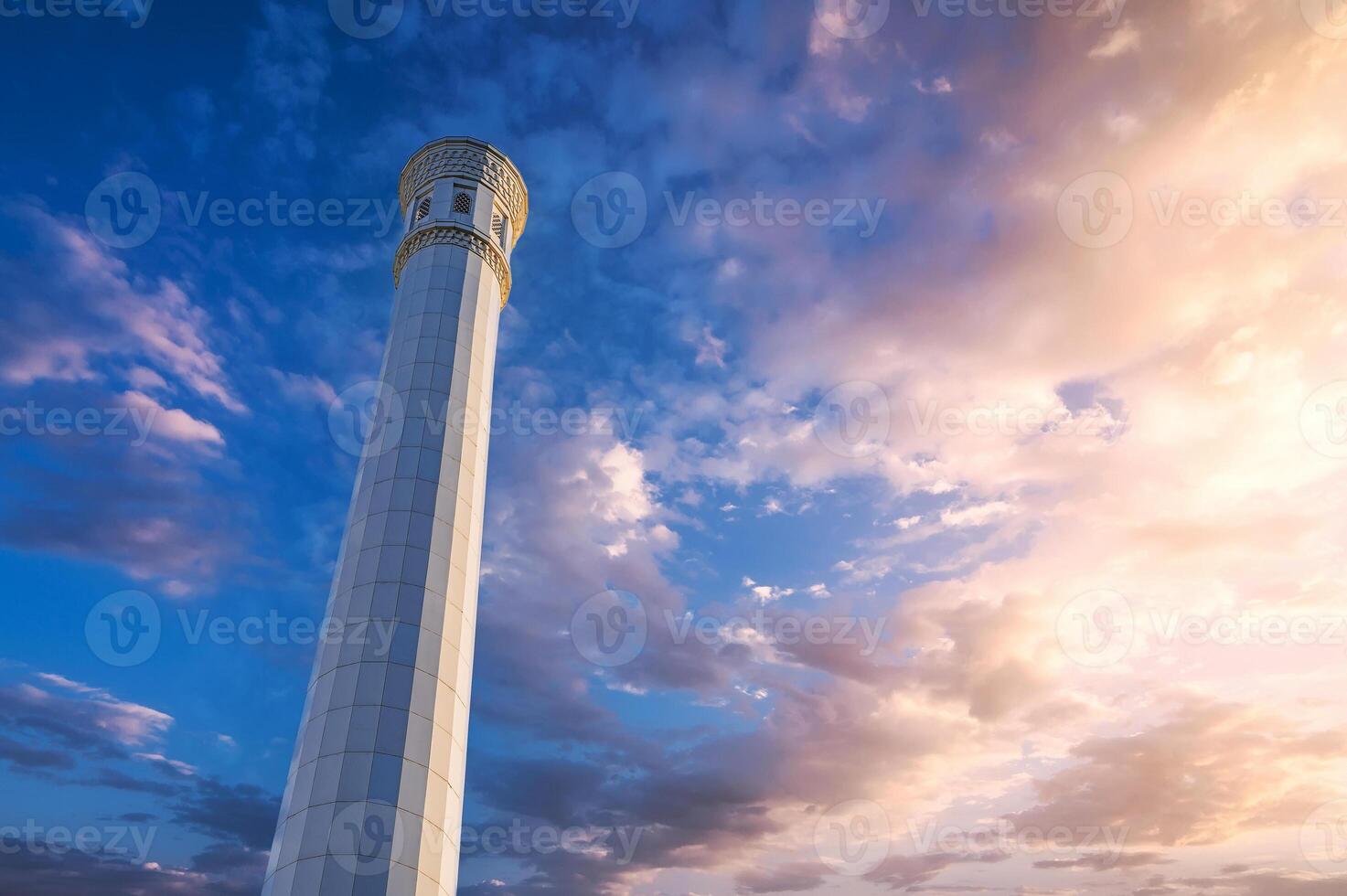 white islamic minaret of modern new Masjid Minor Mosque in Tashkent in Uzbekistan on background of sunrise sky photo