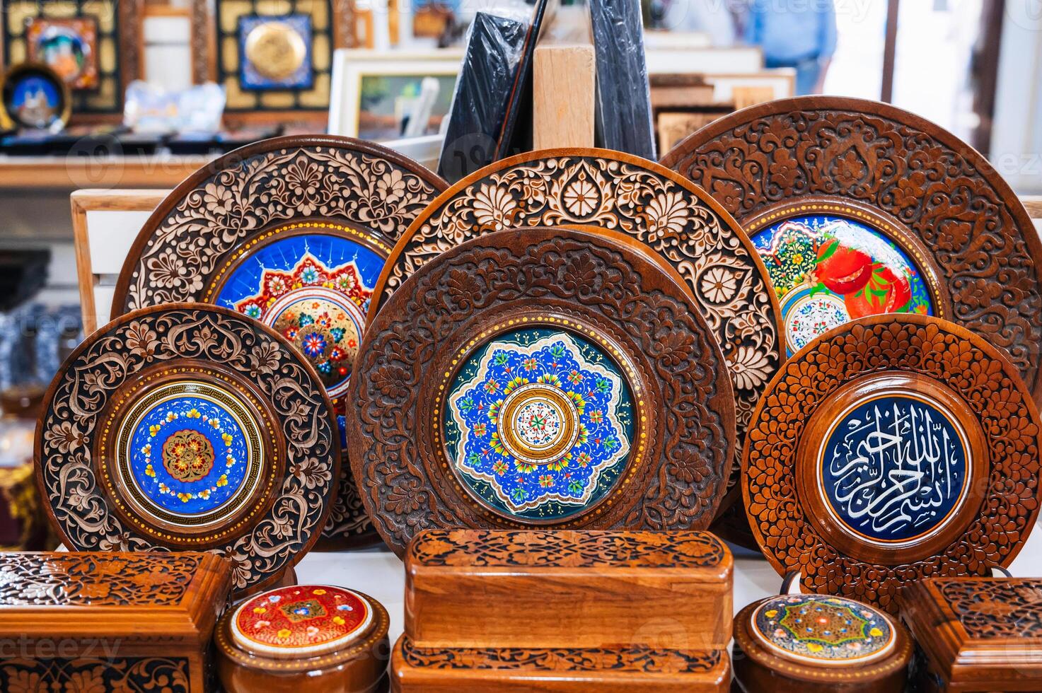 handmade Uzbek wooden gift plates and caskets with wood carvings in souvenir shop of Uzbekistan in Tashkent photo