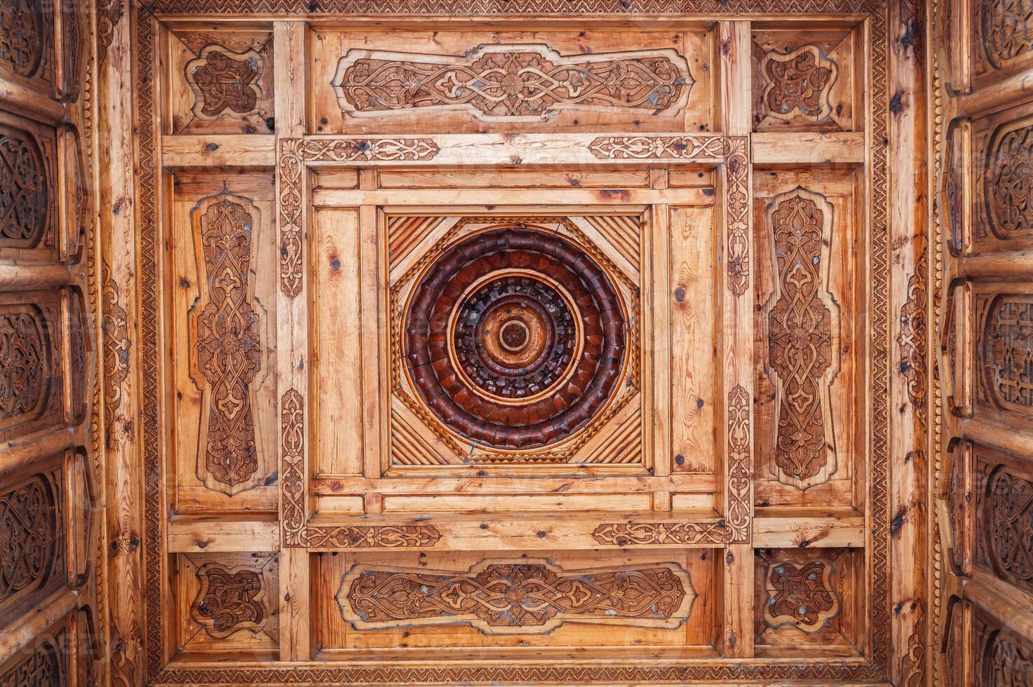 carved wooden ceiling with oriental pattern Uzbek ornament in Museum of Victims of Political Repression in Tashkent in Uzbekistan photo