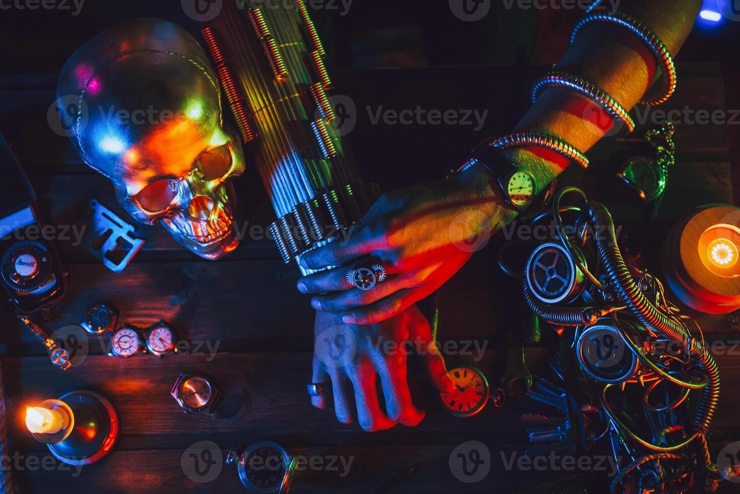 Cyberpunk atmosphere. Hands of a male inventor engineer on a table with various steampunk mechanisms photo
